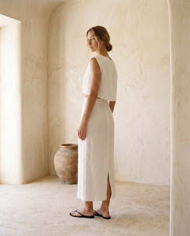 The Alora Linen Blend Set in white — linen-blend top and maxi skirt, side view on model