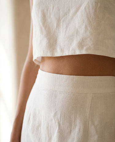 The Alora Linen Blend Set in white — close-up of skirt waistband and cropped top hem