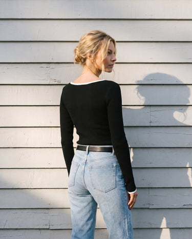 Back view of the black ribbed knit top showing the contrast-trimmed neckline – Moriel Heritage