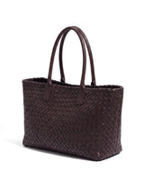The Amalfi Woven Tote in brown, three-quarter studio hero view showing the woven leather and rolled handles