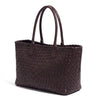 The Amalfi Woven Tote in brown, three-quarter studio hero view showing the woven leather and rolled handles