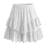 The Amour Lace Mini Skirt in white — tiered ruffle eyelet-lace mini skirt, product flat-lay
