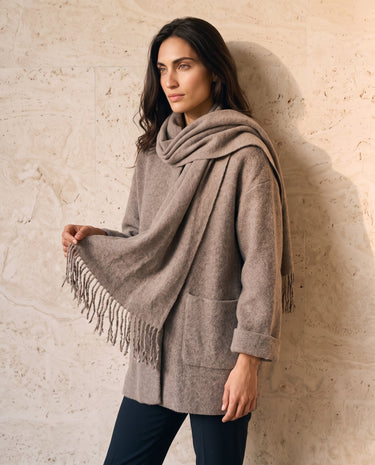 The Aria Scarf Cape Coat in khaki — coat with fringed scarf draped over shoulder, front view on model