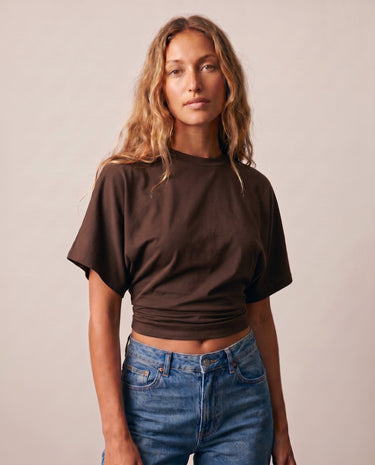 Model wearing the brown ruched-side tee with jeans, front view – Moriel Heritage