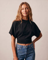 Model wearing the black ruched-side tee with jeans, front view – Moriel Heritage