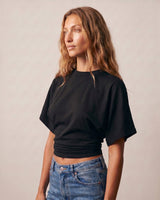 Model in the black ruched-side tee, angled front view – Moriel Heritage