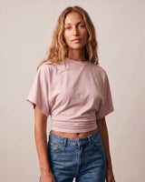 Front view of the pink ruched-side tee showing the cropped hem – Moriel Heritage