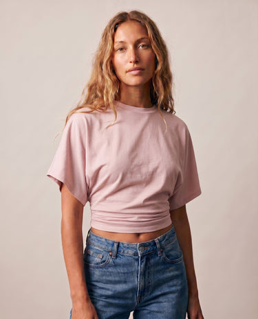 Front view of the pink ruched-side tee showing the cropped hem – Moriel Heritage