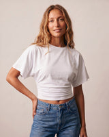 Model with hand on hip wearing the white ruched-side tee – Moriel Heritage