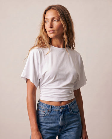 Front view of the white ruched-side tee worn with blue jeans – Moriel Heritage