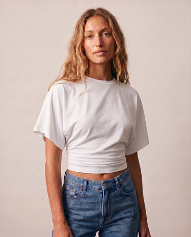 Front view of the white ruched-side tee showing the cropped hem – Moriel Heritage