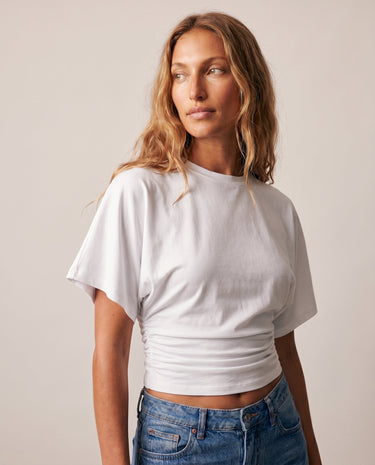 Three-quarter view of the white ruched-side tee – Moriel Heritage