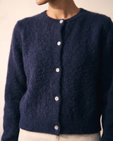 The Arlo Cardigan in navy — close-up of the button placket and rounded neckline