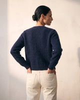 The Arlo Cardigan in navy — back view on model