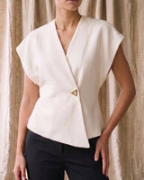 The Asymmetrical Vest in white — sleeveless vest with drop shoulders and V wrap front, front view on model
