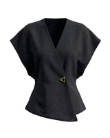 The Asymmetrical Vest in black — textured sleeveless vest with V wrap front and single button, product flat-lay