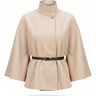 The Aurelia Shawl in beige — belted cape with stand collar and gold button, product flat-lay