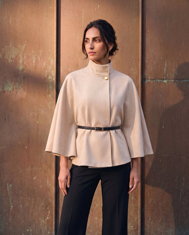 The Aurelia Shawl in beige — front three-quarter view on model