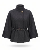 The Aurelia Shawl in black — belted cape with stand collar and gold button, product flat-lay