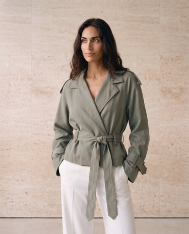 The Avielle Belted Trench in green — belted trench jacket with wrap tie waist, front view on model