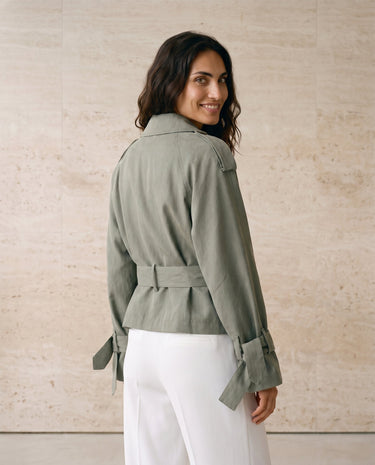 The Avielle Belted Trench in green — belted trench jacket showing back and tie belt, back view on model