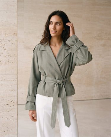 The Avielle Belted Trench in green — belted trench jacket, three-quarter front view on model