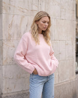 The Blush Sweater in pink — front view on model