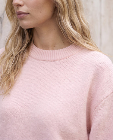 The Blush Sweater in pink — close-up of the crew neckline