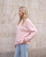 The Blush Sweater in pink — side view on model