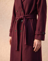 The Burgundy Celine Coat in burgundy — close-up of the tie belt and buttoned cuff