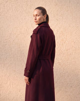 The Burgundy Celine Coat in burgundy — back three-quarter view on model