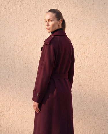 The Burgundy Celine Coat in burgundy — back three-quarter view on model