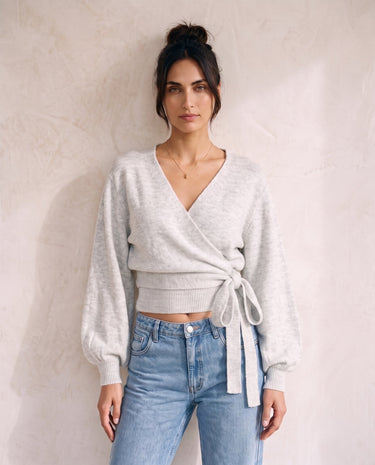 The Calira Wrap Knit in gray — knit wrap top showing side tie, front view on model