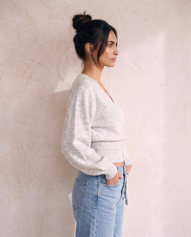 The Calira Wrap Knit in gray — knit wrap top, side view on model