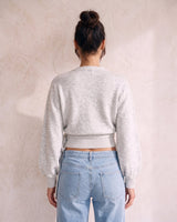 The Calira Wrap Knit in gray — knit wrap top, back view on model