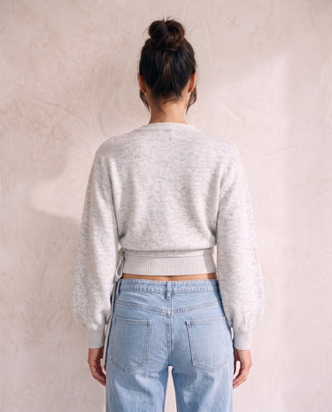 The Calira Wrap Knit in gray — knit wrap top, back view on model