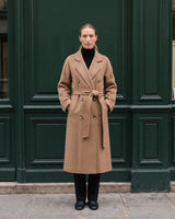 The Calvera double-breasted wool coat in khaki — full-length front view with hands in pockets on model