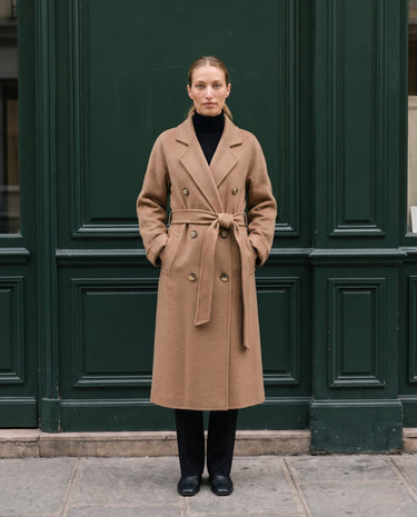 The Calvera double-breasted wool coat in khaki — full-length front view with hands in pockets on model
