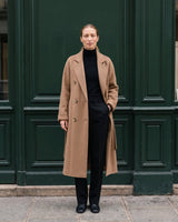The Calvera double-breasted wool coat in khaki — front view with hand in pocket on model