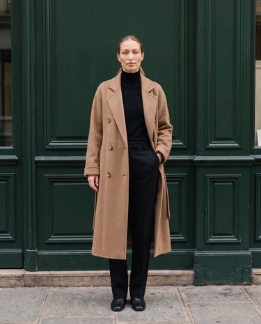 The Calvera double-breasted wool coat in khaki — front view with hand in pocket on model