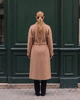 The Calvera double-breasted wool coat in khaki — back view on model
