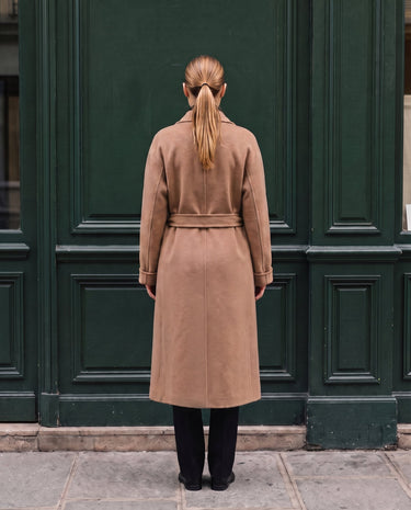 The Calvera double-breasted wool coat in khaki — back view on model