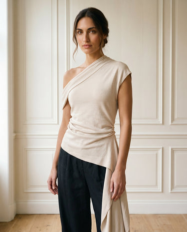 The Camellia Ruffle Top in beige — asymmetric one-shoulder ruffle top, front styling view on model