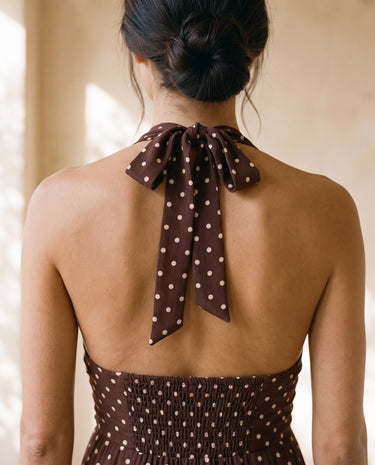 The Capri Polka Dot Dress in brown — close-up of halter tie neck and shirred back