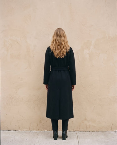 The Caroline Tie Waist Coat in black — longline belted coat, back view on model