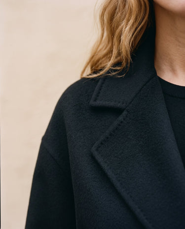 The Caroline Tie Waist Coat in black — close-up of the lapel collar and shoulder