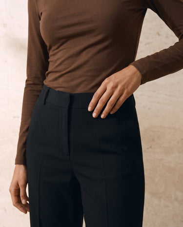 The Celeste Asymmetrical Long Sleeve Top in coffee — close-up of fitted waist and long sleeve