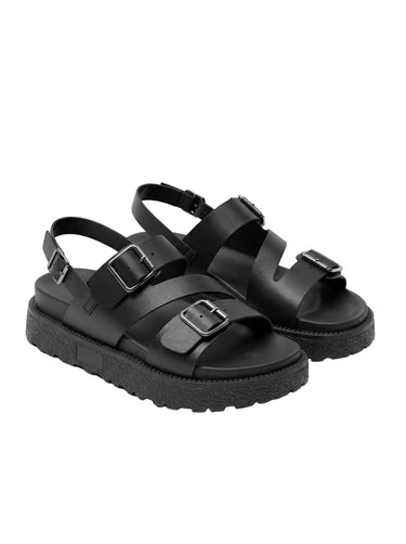 The Celeste Sandal in black — chunky platform sandals with double buckle straps, angled pair view