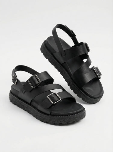 The Celeste Sandal in black — chunky platform sandals with ankle strap, elevated pair view