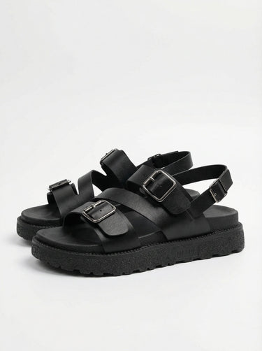 The Celeste Sandal in black — buckled strap platform sandal, single shoe side view